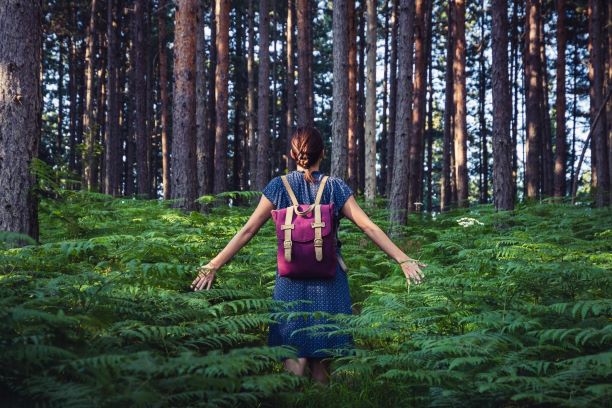 Woman walking in nature forest fern